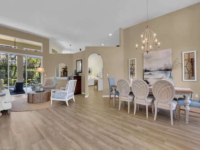 Dining room featuring light hardwood / wood-style floors, an inviting chandelier, and high vaulted ceiling