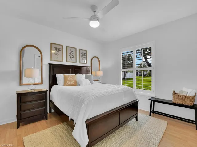 Bedroom with ceiling fan and light wood-type flooring