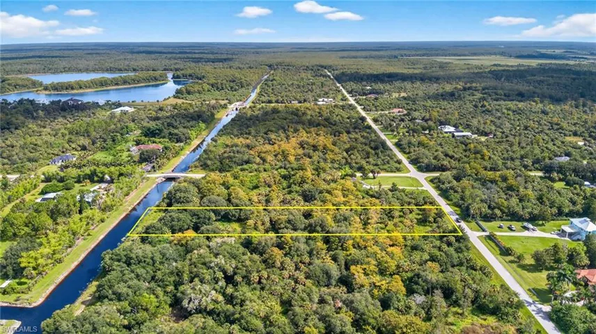 Aerial view of property's location with property parcel outlined and a nearby body of water