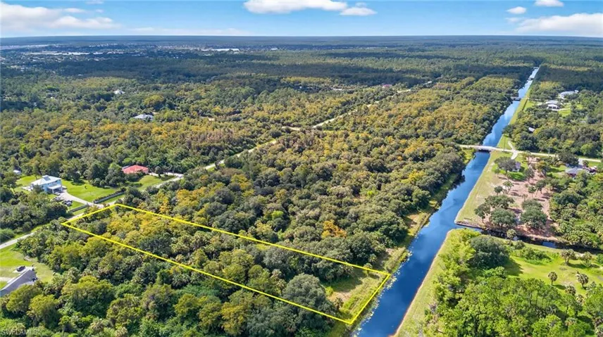Aerial view of property's location with property boundaries highlighted and a large body of water