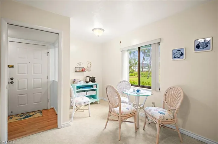 Dining room with baseboards and light carpet