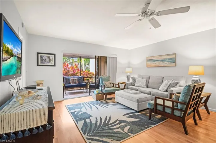 Living room with wood finished floors and a ceiling fan
