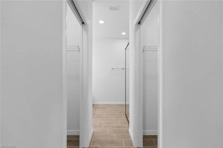 Hallway with recessed lighting and wood tiled floors