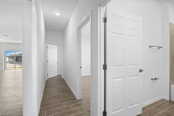 Hall with wood finish floors and baseboards