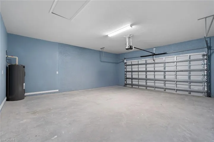 Garage with electric water heater and a garage door opener