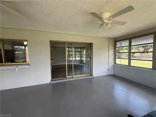 Spare room featuring a textured ceiling and ceiling fan