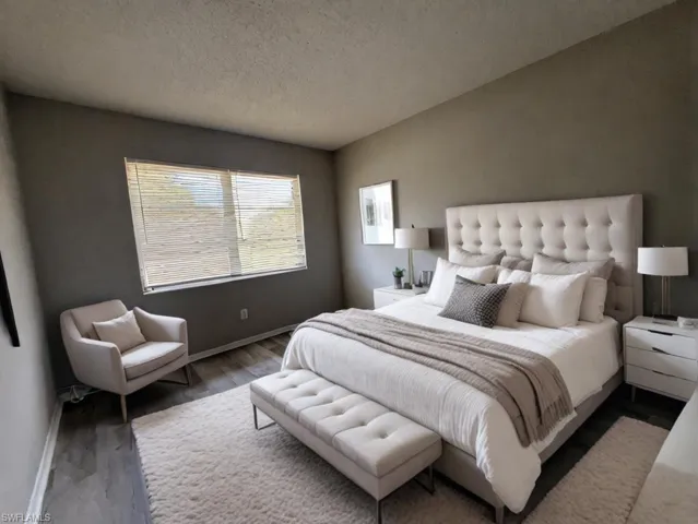 Bedroom with hardwood / wood-style floors and a textured ceiling