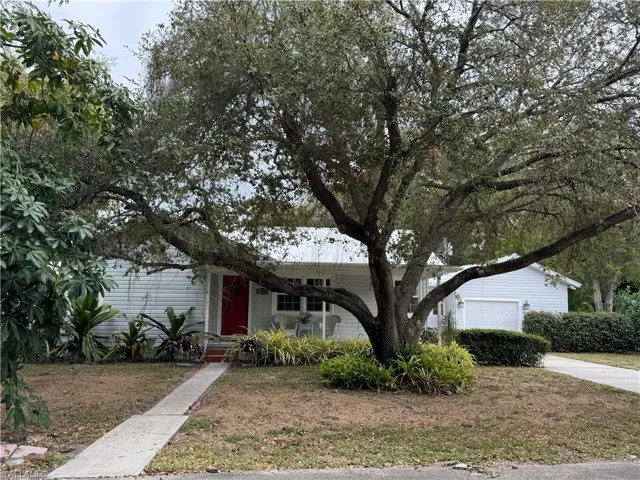 View of front of home featuring a front yard and a garage