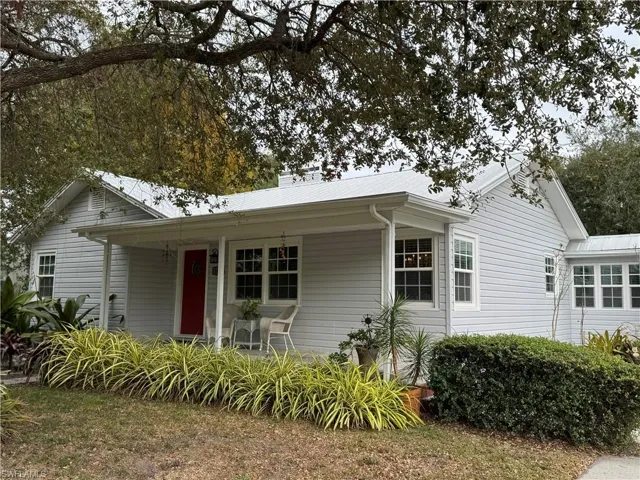 View of front facade with a chimney and a metal roof