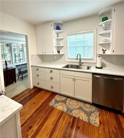 Kitchen featuring open shelves, white cabinetry, stainless steel appliances
