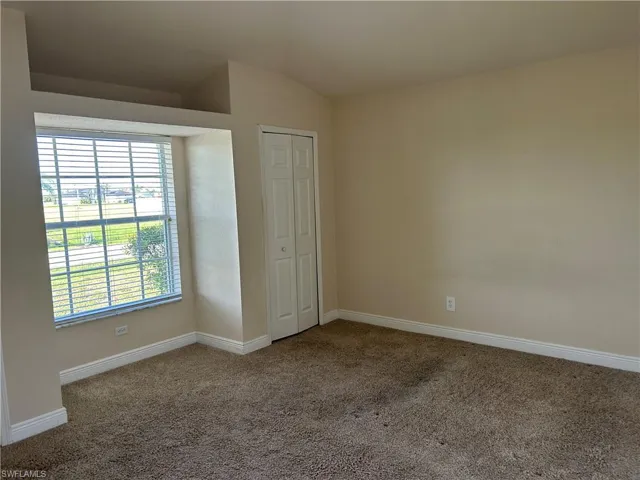 Unfurnished bedroom with carpet floors and a closet