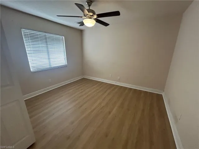 Empty room featuring wood finished floors and ceiling fan