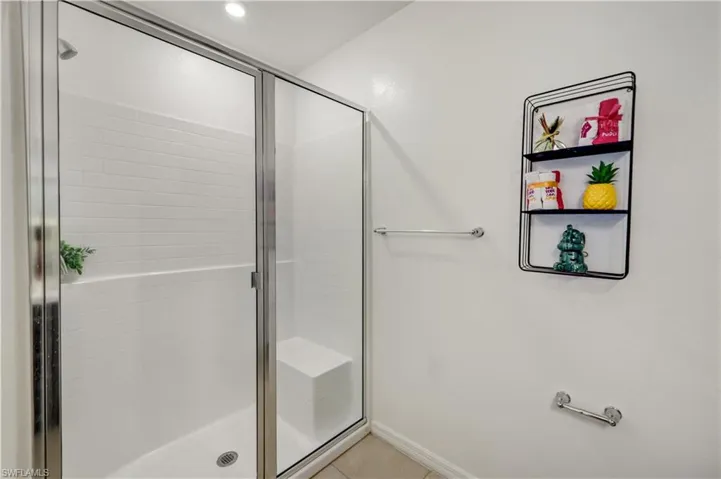 Bathroom featuring tile patterned floors and an enclosed shower