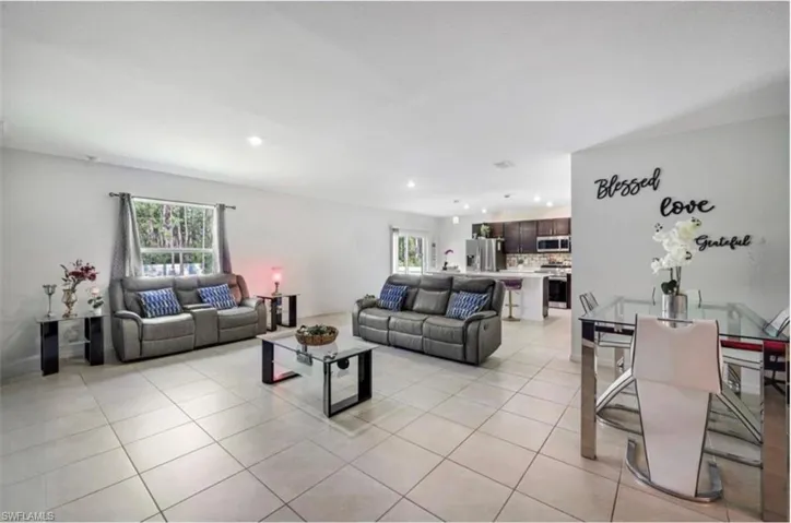 Living room with light tile patterned flooring