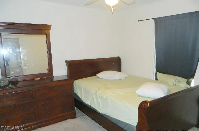 Bedroom featuring light colored carpet and ceiling fan