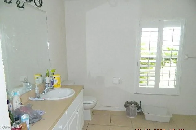 Bathroom with light tile patterned floors and vanity