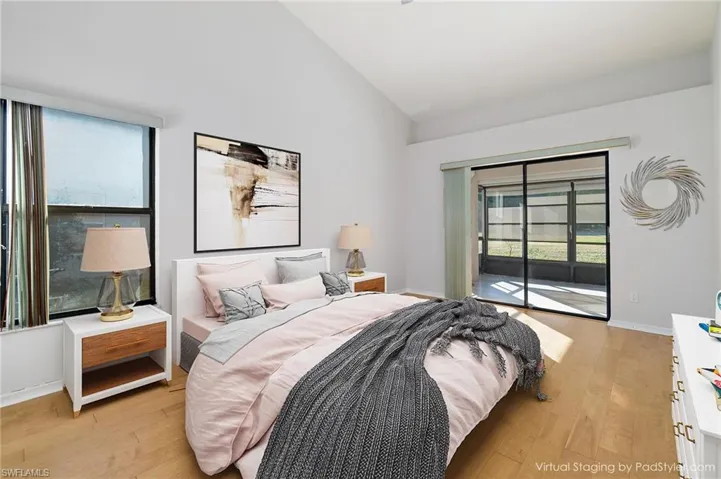 Primary Bedroom all en-suite Virtually Staged featuring soaring vaulted ceilings, access to Florida Room, light hardwood / wood-style flooring, and walk-in closet.