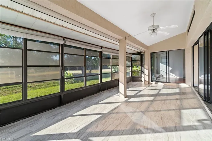 Westerly facing Florida Room/ sunroom featuring ceiling fan, a healthy amount of sunlight, and vaulted ceilings with access from both Kitchen eating area and main living room