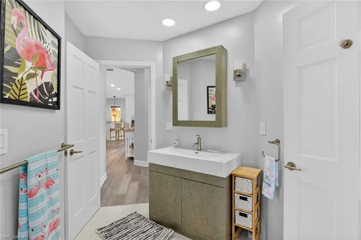 A view of the guest bath showing access to the family room/kitchen area