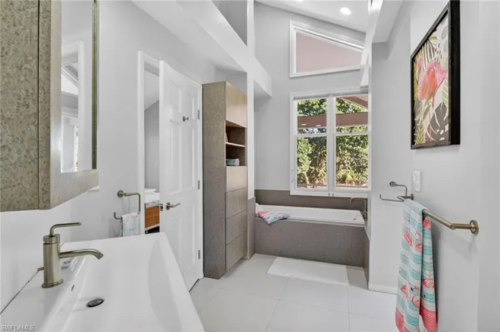This guest bath has both a tub and shower and can be accessed from the guest bedrooms and the pool so no getting wet footprints through the house while enjoying the outdoor fun