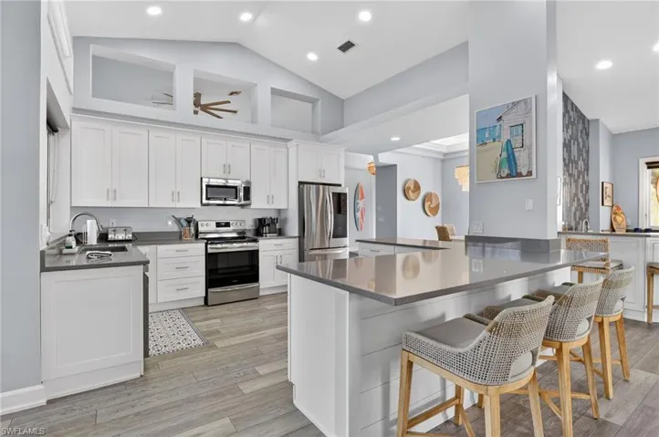 All stainless steel appliances and tons of space in this large, bright kitchen