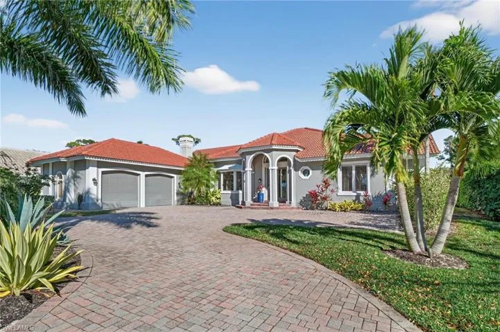 Large pavered circular driveway leads you to the entrance