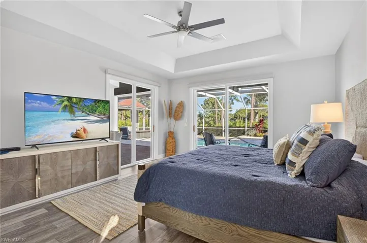 The primary bedroom has sliding doors to the lanai offering access to the pool and outdoor dining as well as gorgeous natural light.