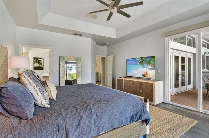 The spacious primary bedroom has access to the lanai and automated blinds for when you want to sleep in