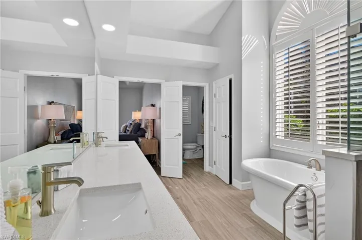 Natural light shines through the primary bathroom
