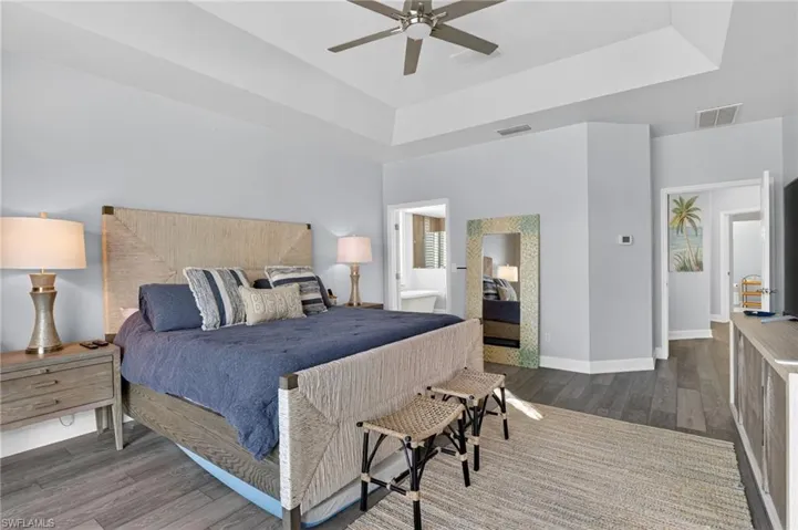 The large primary bedroom has tray ceilings and an en suite bathroom