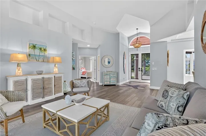 This view within the living room shows the home's entryway and a peek into the front, guest bedroom