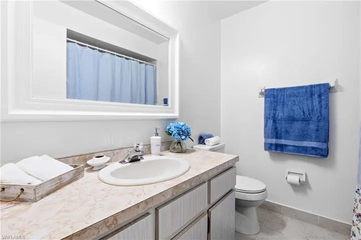 Full bath featuring vanity and toilet