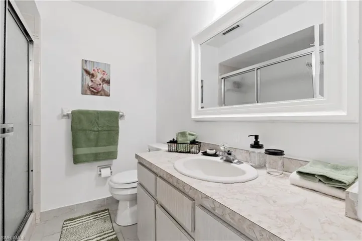 Bathroom with vanity and a shower stall