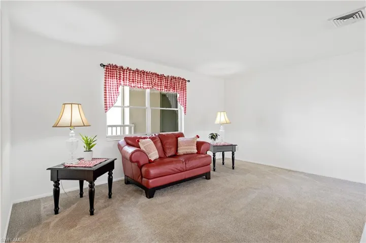 Carpeted living room with baseboards