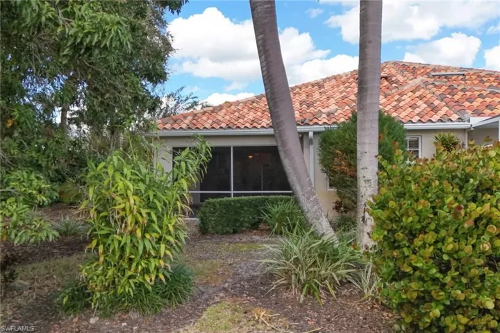 Back of property with a sunroom
