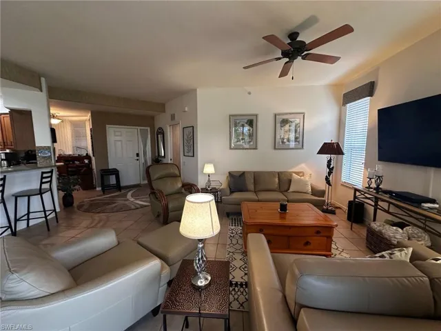 Living room featuring ceiling fan and light tile patterned floors