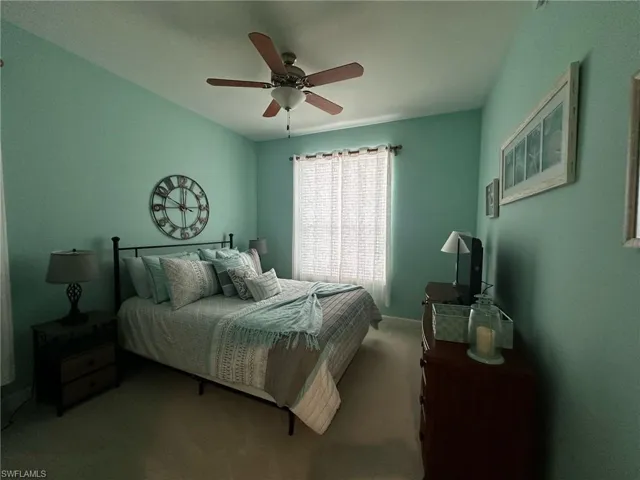 Bedroom with ceiling fan and carpet flooring