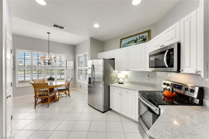 Open to Kitchen, your Morning Room/Breakfast space is a pleasure with views to your lake and sliders (out of pic) to the left of table.
