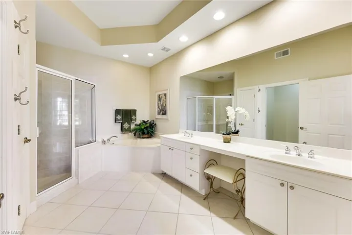 The bright en-suite Master Bathroom has double sinks separated by vanity space, separate shower and soaking tub. Water closet to left.