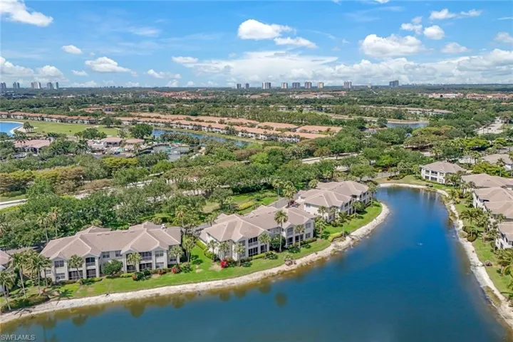 Bird's eye view of southwest of your 1st floor end condo which is in center of this picture next to red flowering bush..
