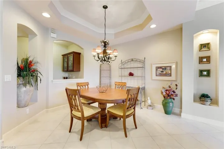 Coffered ceiling with crown molding and wet-bar pass-through all for luxury and convenience for serving.