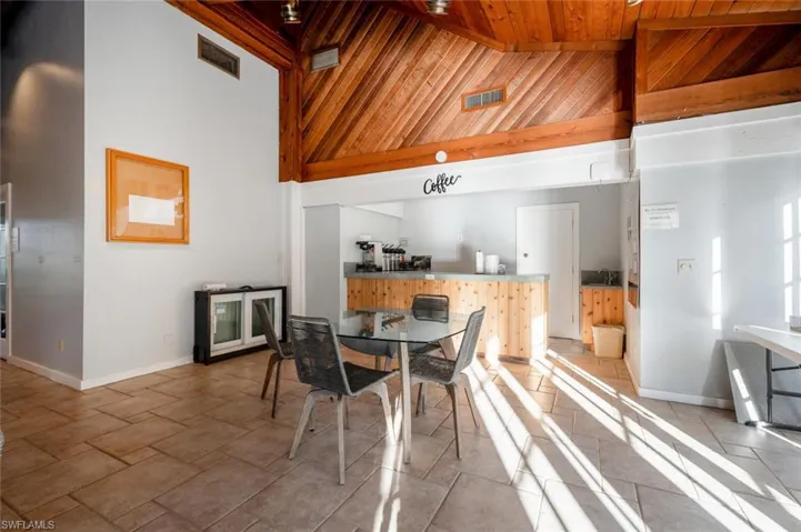 Dining room with high vaulted ceiling and wooden ceiling