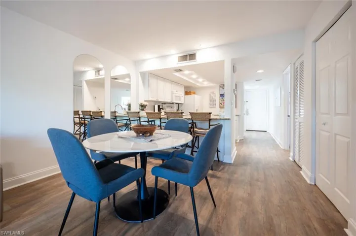 Dining room with dark hardwood / wood-style floors