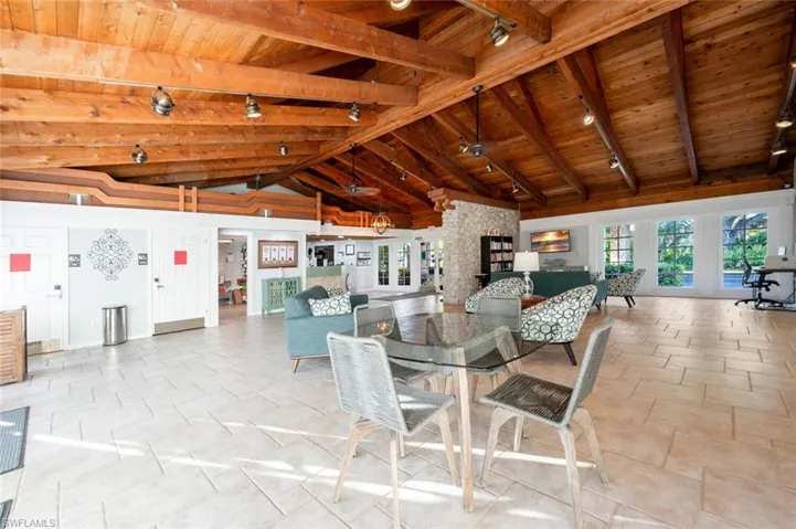 Dining area with beam ceiling, high vaulted ceiling, and wooden ceiling