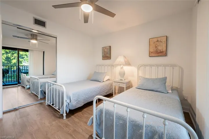 Bedroom featuring access to outside, ceiling fan, a closet, and wood-type flooring