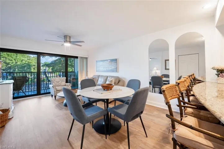Dining space with light hardwood / wood-style floors and ceiling fan
