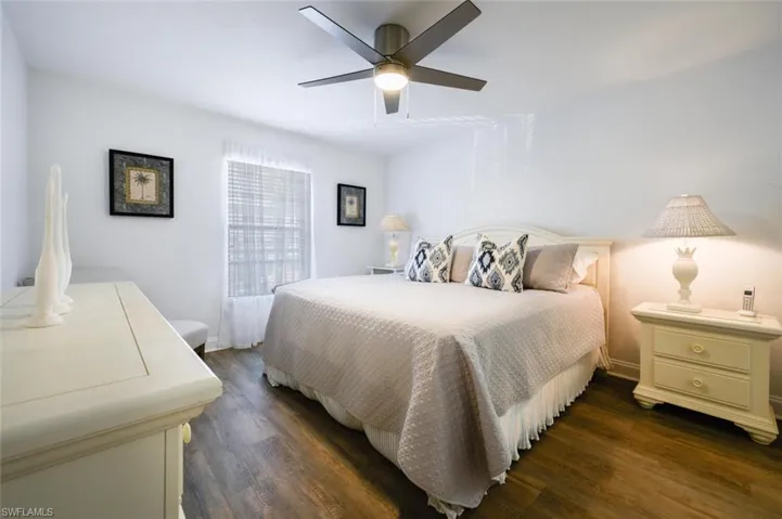 Bedroom with ceiling fan and dark hardwood / wood-style flooring