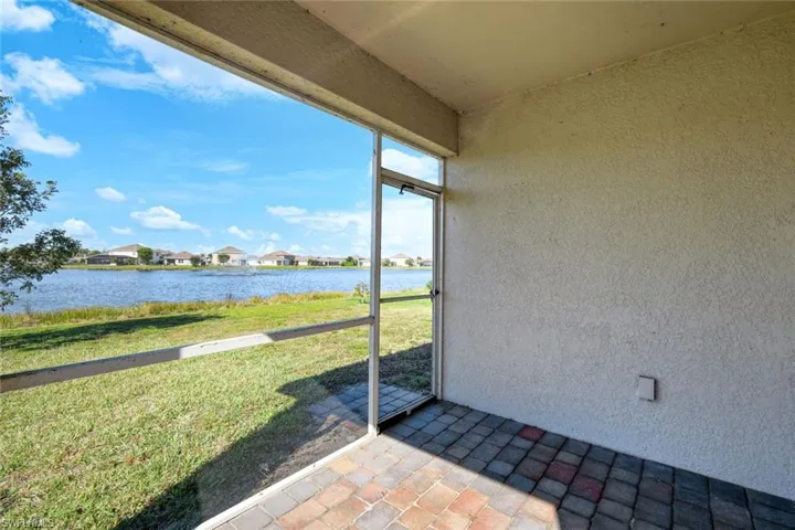 Unfurnished sunroom featuring a water view