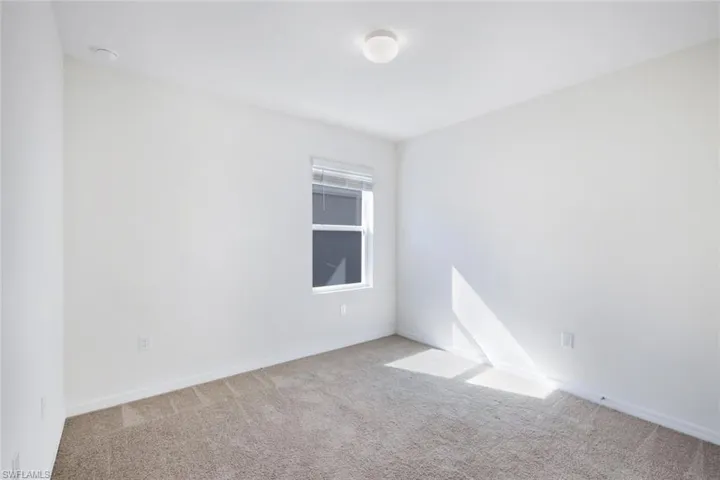 Spare room with light colored carpet