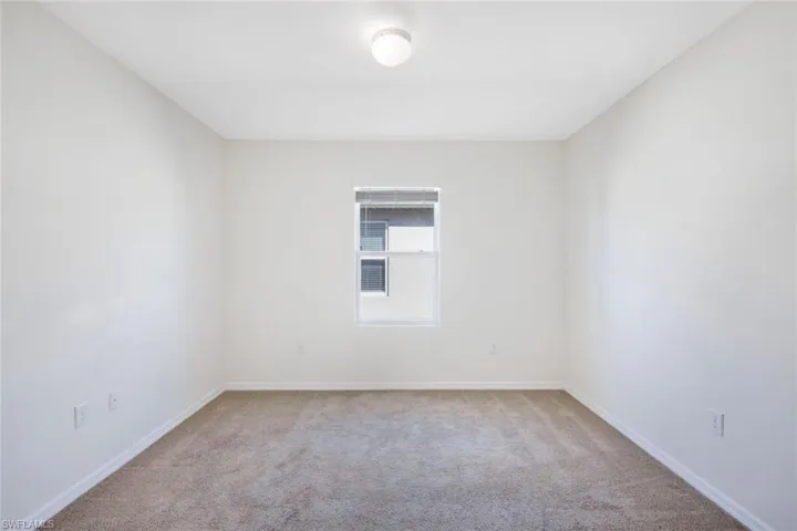 Unfurnished room featuring light colored carpet
